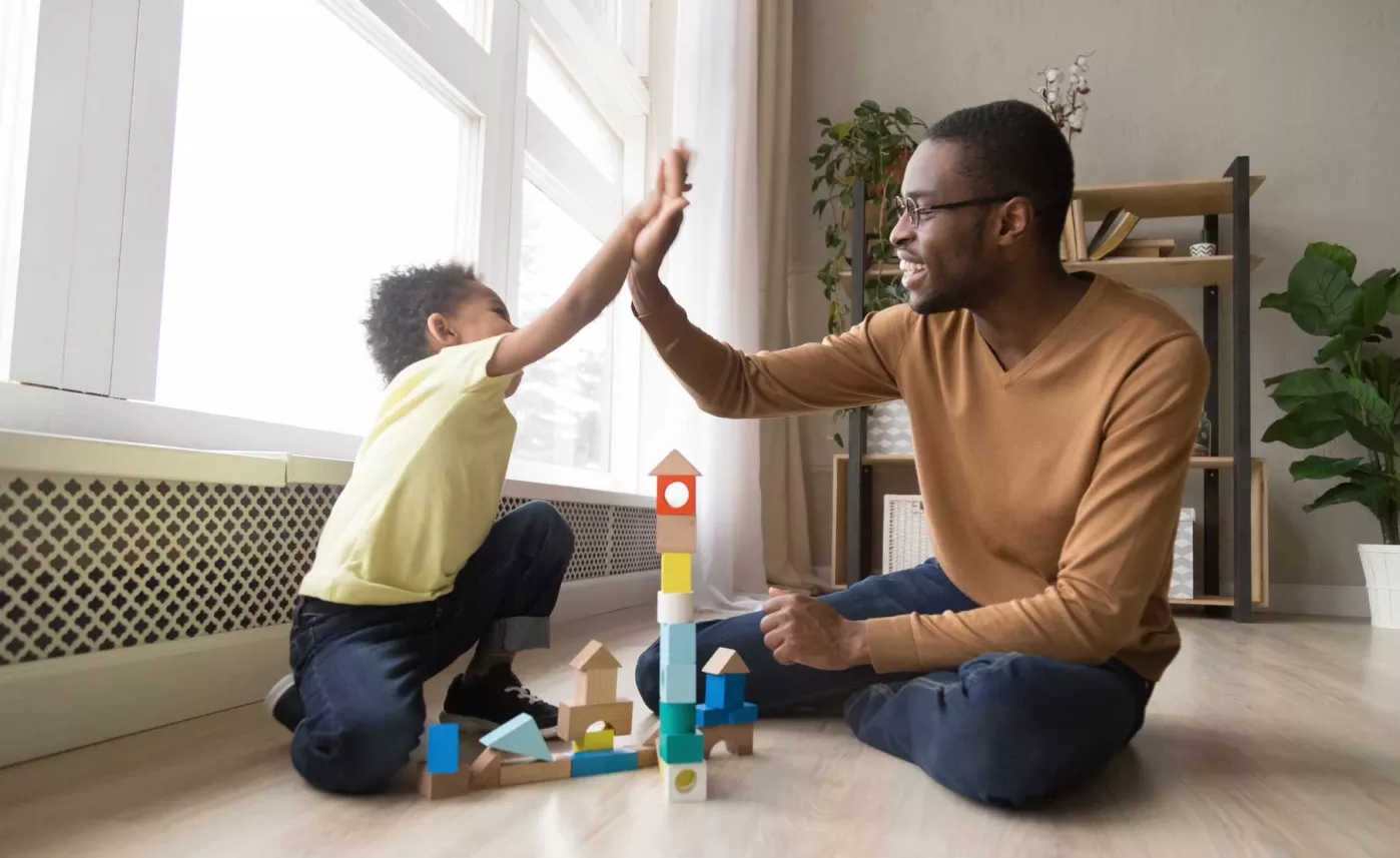  Father and child enjoy playing block games

