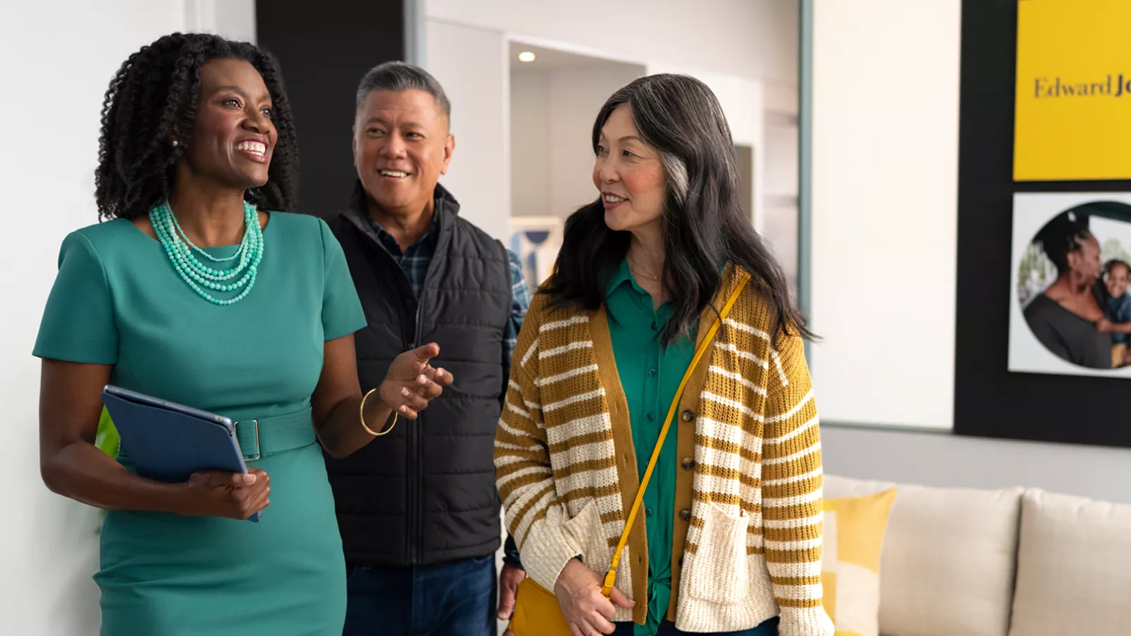  Financial advisor and a man and woman walking and talking.
