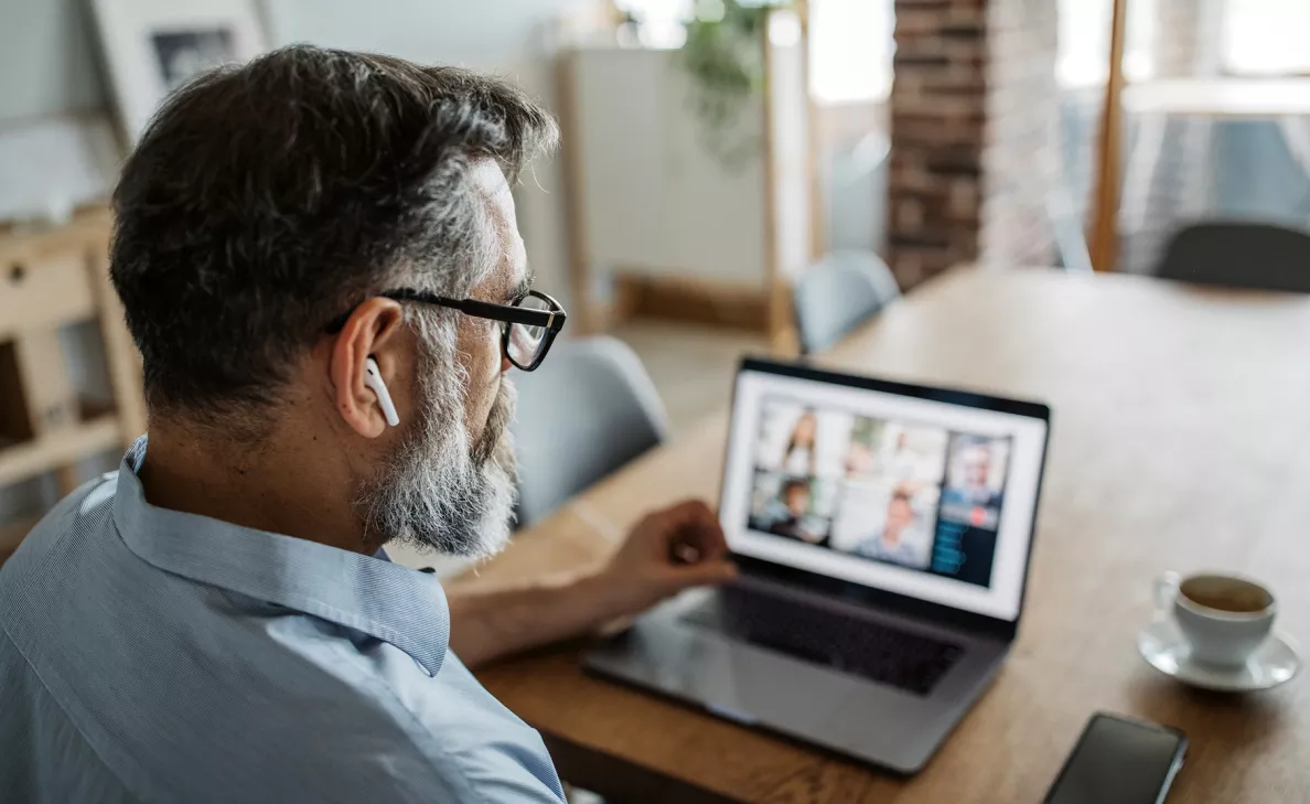  A business owner reviews employee information on his laptop.
