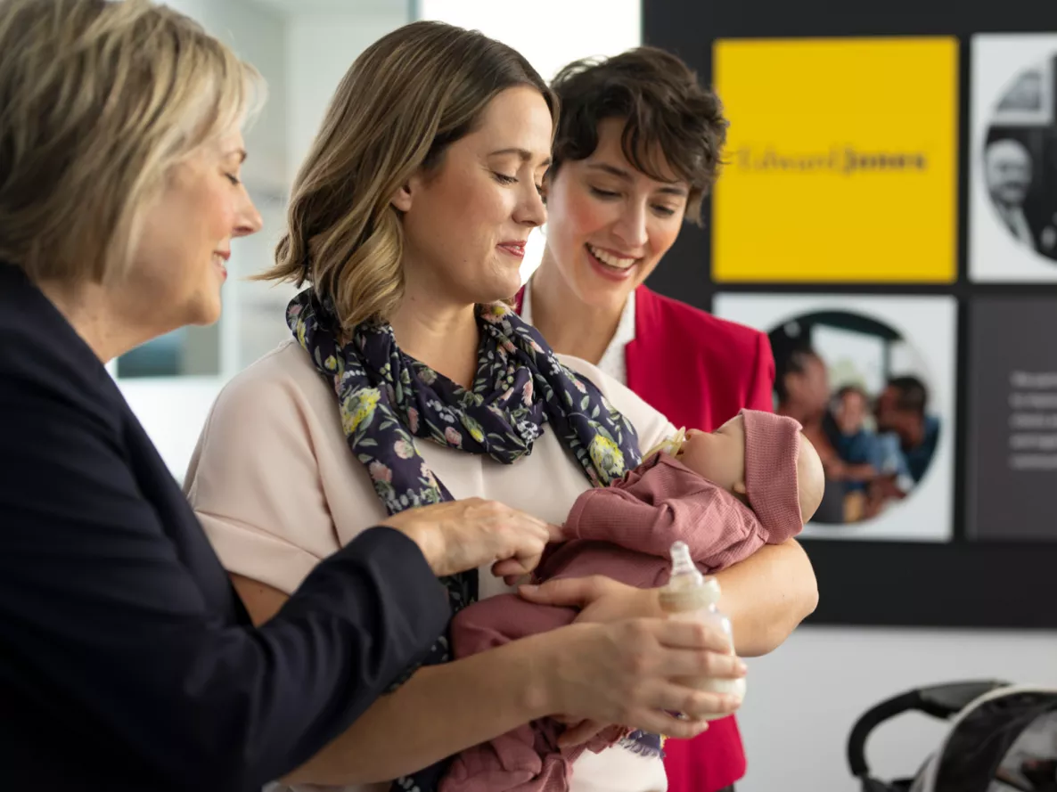  Four generation photo of a woman holding her baby and her mother and grandmother standing beside them.
